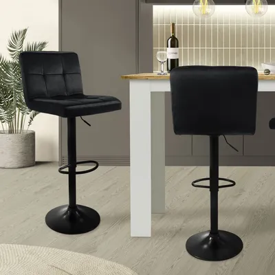 Two black bar stools are shown in a kitchen or dining area.