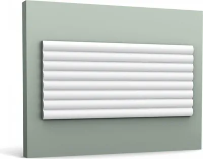 A white decorative wall panel with a ribbed texture is mounted on a light green wall.