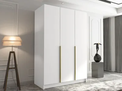 A modern white wardrobe with gold handles is shown in a well-lit room.