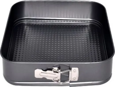 A square baking pan with a removable side and a textured bottom.
