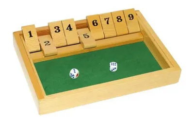 A wooden board game with numbered tiles and dice on a green felt surface.