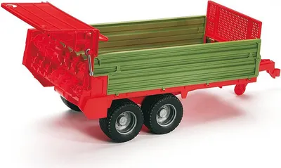 A toy agricultural trailer with a red front mechanism and green sides, shown on a white background.