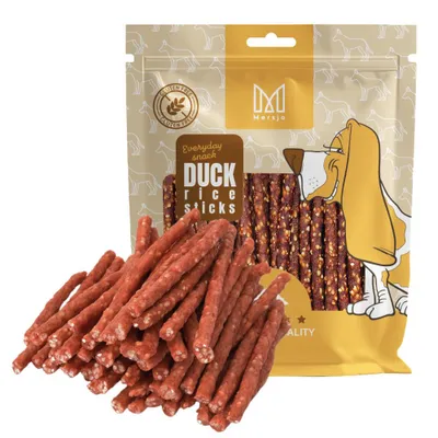 A bag of dog treats with some treats spilled in front of it.