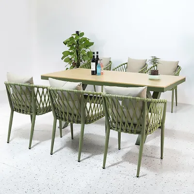An outdoor dining set with a table and six chairs, set against a plain white background.
