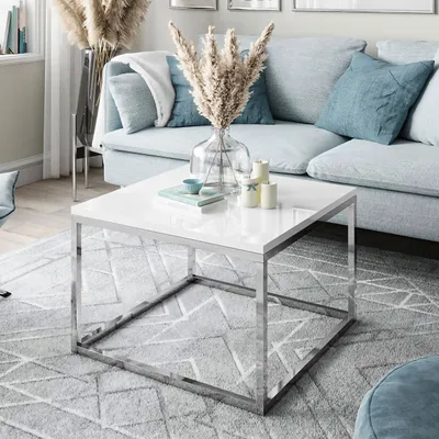 A modern living room scene with a light blue sofa, a white coffee table, and a grey rug.