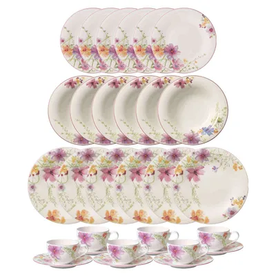 A set of floral patterned dinnerware and teacups is displayed against a white background.