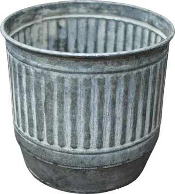 A close-up studio shot of a galvanized metal planter.