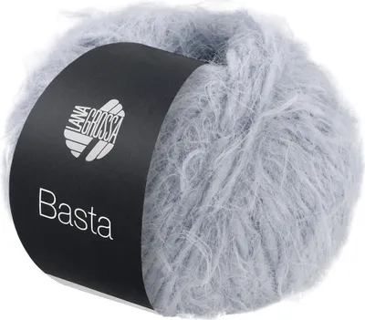 A ball of fluffy yarn with a black label wrapped around it.