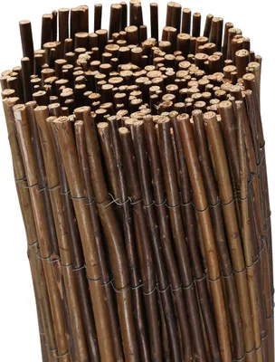 A rolled-up bundle of natural willow branches tied together with wire, forming a privacy screen or fence.