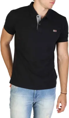 A man wearing a black polo shirt and blue jeans.