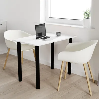 A small dining table with two chairs in a bright, modern room setting.