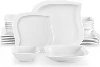A collection of white porcelain dinnerware, including plates and bowls, arranged on a white background.