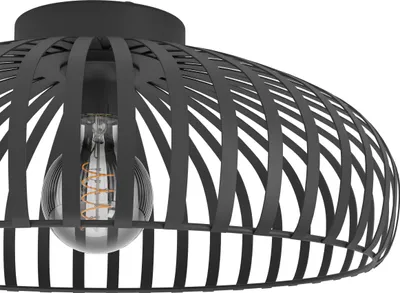 A close-up view of a black metal ceiling lamp with a visible light bulb.