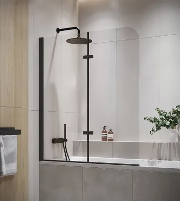 A modern bathroom with a bathtub and shower screen.