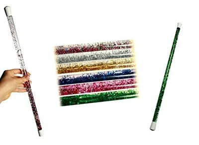 A hand holding a glitter wand, with a collection of glitter wands in the background and another glitter wand on the right.