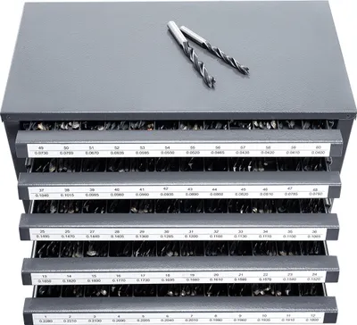 A gray metal organizer cabinet with multiple drawers filled with drill bits. Two drill bits are placed on top of the cabinet.