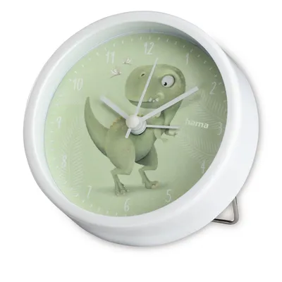 A close-up, angled view of a white alarm clock with a green face featuring a cartoon dinosaur illustration.