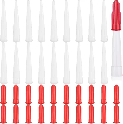 A collection of white and red plastic nozzle tips for caulking guns.