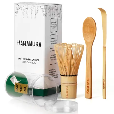 A matcha tea set is displayed on a white background, including a whisk, spoon, and scoop, along with its packaging.