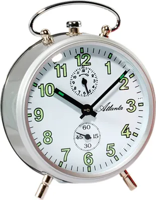 A close-up studio shot of a silver analog alarm clock with a white face.