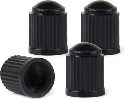 Four black plastic valve caps are arranged on a white background. One cap is shown from the side, revealing its threaded interior, while the other three are shown from the top.