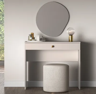 A vanity table with a mirror and stool in a room.