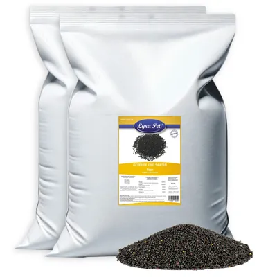 Two large white bags of birdseed with a label and a pile of birdseed in the foreground.