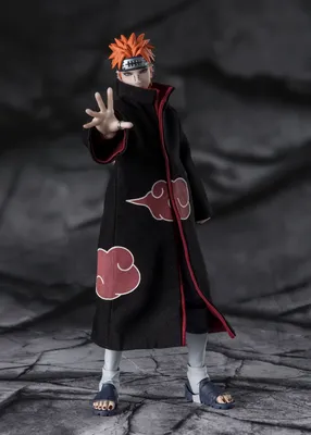 A full-body shot of an action figure of the character Pain Tendo from Naruto Shippuden, standing on a textured gray surface against a dark gray background.