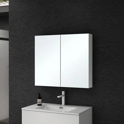 A modern bathroom vanity with a mirrored cabinet above a sink.