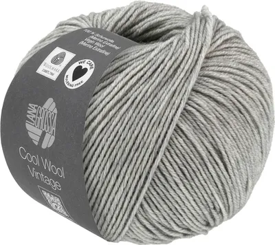 A ball of gray yarn with a label wrapped around it.