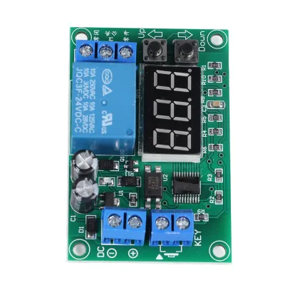 A close-up, top-down view of a digital timer relay module circuit board against a white background.