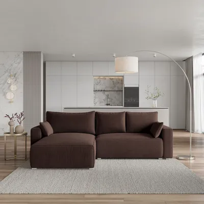 A modern living room with a sectional sofa in front of a kitchen area.