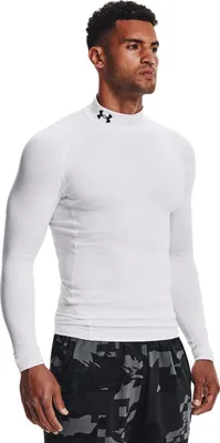 A man wearing a white long-sleeved shirt and patterned shorts.