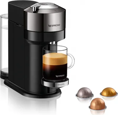 A Nespresso Vertuo Next coffee machine with a cup of coffee and three coffee pods.