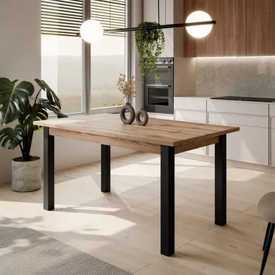 A dining table in a modern kitchen setting with a large window overlooking a landscape.