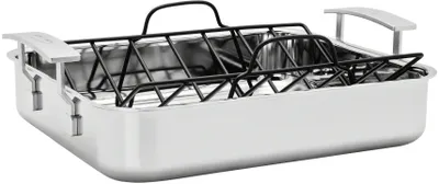 A stainless steel roasting pan with a black wire rack insert.