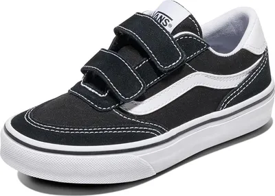 A black Vans sneaker with white accents and velcro straps is shown against a white background.