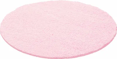 A round, pink, shaggy rug.