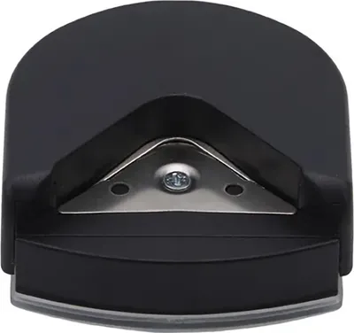 A close-up, top-down view of a black corner rounder tool with a silver metal blade.