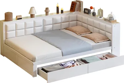 A white corner bed with storage drawers underneath, decorated with various items on the headboard shelf.