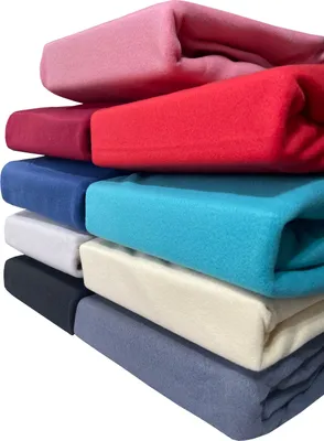 A stack of folded fleece sheets in various colors.