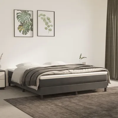 A bedroom scene with a bed, nightstand, and artwork on the wall.