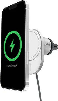 A smartphone is attached to a car charger mount, showing it is charging.