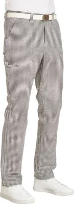 A person wearing checkered pants and white sneakers, shown from the waist down.
