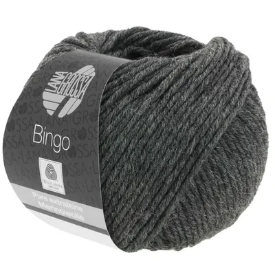 A ball of dark gray yarn with a label wrapped around it.