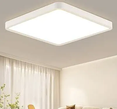 A square LED ceiling light is mounted on a white ceiling, with sheer white curtains visible in the background.