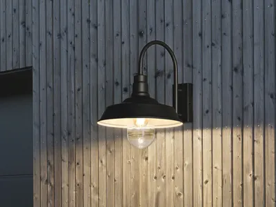 A black outdoor wall light fixture mounted on a wooden wall.