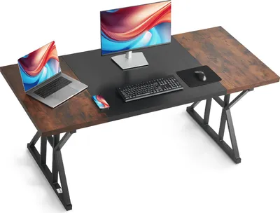 A modern computer desk with a laptop, monitor, keyboard, and mouse.