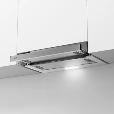 A modern kitchen range hood installed under white cabinets.