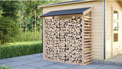 A wooden log store filled with firewood, situated next to a wooden shed in a garden setting.